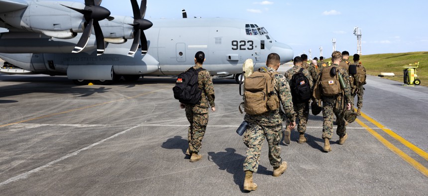 U.S. Marines with III Marine Expeditionary Force Support Battalion, III Marine Expeditionary Force Information Group, board a C-130J Super Hercules on Kadena Air Force Base, Okinawa, Japan, Jan. 20, 2023.