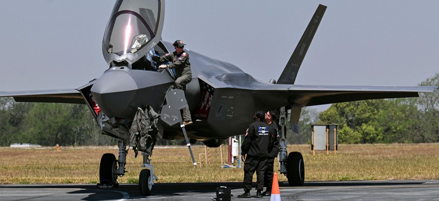 A pilot climbs into the cockpit of a U.S. Air Force F-35 fighter jet at the Aero India 2023 show in Bengaluru on February 14, 2023. 
