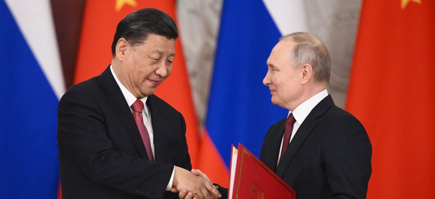 Russian President Vladimir Putin and China's President Xi Jinping shake hands during a signing ceremony following their talks at the Kremlin in Moscow on March 21, 2023.