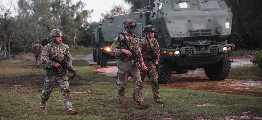 Soldiers with the U.S. Army's 25th Infantry Division escort four HIMARS vehicles of the 17th Field Artillery Brigade to their firing positions at Andersen Air Force Base, Guam, Sept. 26, 2022.