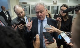  Sen. Tim Kaine (D-VA) speaks to reporters in the Senate subway on his way to a vote at the U.S. Capitol on March 14, 2023.