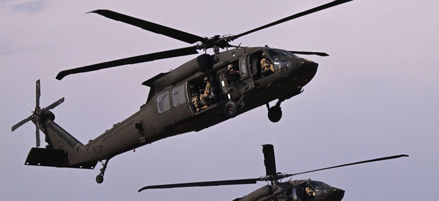 Military personnel of the US Army's 101st Airborne Division take off with Black Hawk helicopters during a demonstration drill at Mihail Kogalniceanu Airbase near Constanta, Romania, on July 30, 2022.