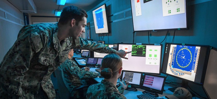 A warfare tactics instructor pilots the U.S. Navy’s virtual combat curriculum with sailors aboard USS Paul Hamilton (DDG 60) inside a portable simulator in 2020. 