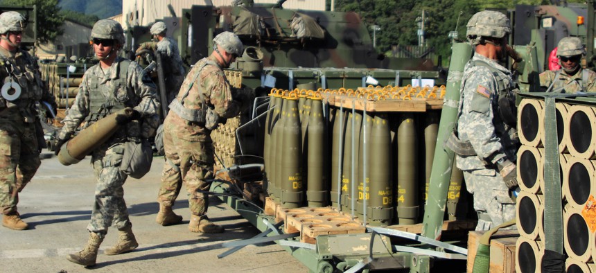 In this 2016 photo, soldiers of the U.S. Army's 1st Cavalry Division move 155mm Dual Purpose Improved Conventional Munition rounds—cluster munitions—at a base in South Korea. 