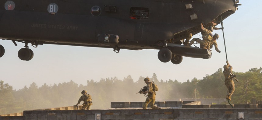 A U.S. Army Special Forces team fast-ropes onto a building at Fort Bragg, North Carolina, on April 28, 2023. The landing was part of a training exercise that simulated operations against Chinese forces in Taiwan.