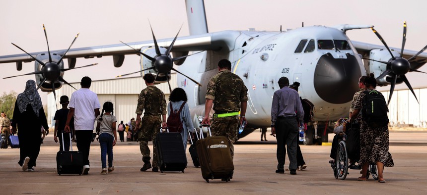 In this handout image provided by the UK Ministry of Defence, British nationals board an RAF aircraft in Khartoum, Sudan, on April 26, 2023, for evacuation to Larnaca International Airport in Cyprus.