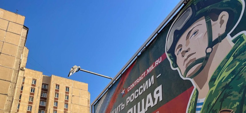  billboard promoting contract army service and reading "Serving Russia is the real job" sits in Saint Petersburg on April 23, 2023. (Photo by Kirill KUDRYAVTSEV / AFP