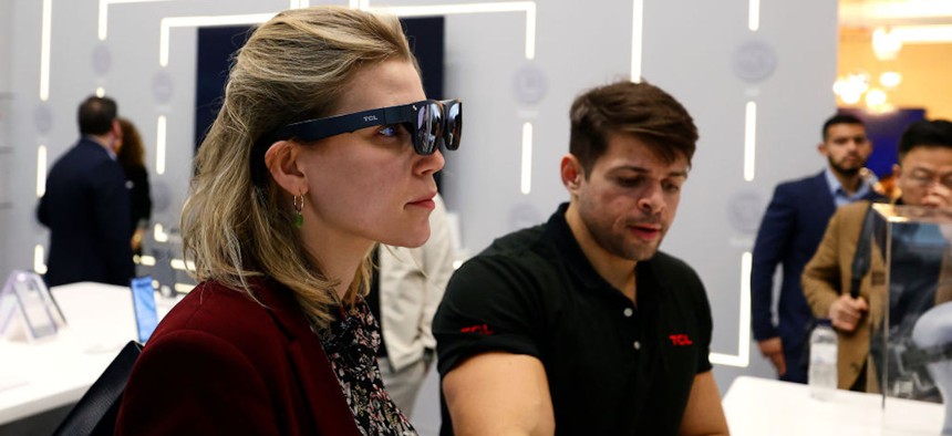A visitor tries the TCL RayNeo X2 augmented-reality glasses during the Mobile World Congress 2023 on March 2, 2023, in Barcelona, Spain.