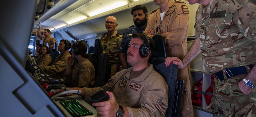 Personnel from Bahrain, France, United Kingdom and United States conduct a multilateral patrol in a U.S. Navy P-8A Poseidon aircraft over the Strait of Hormuz, May 14, 2023.