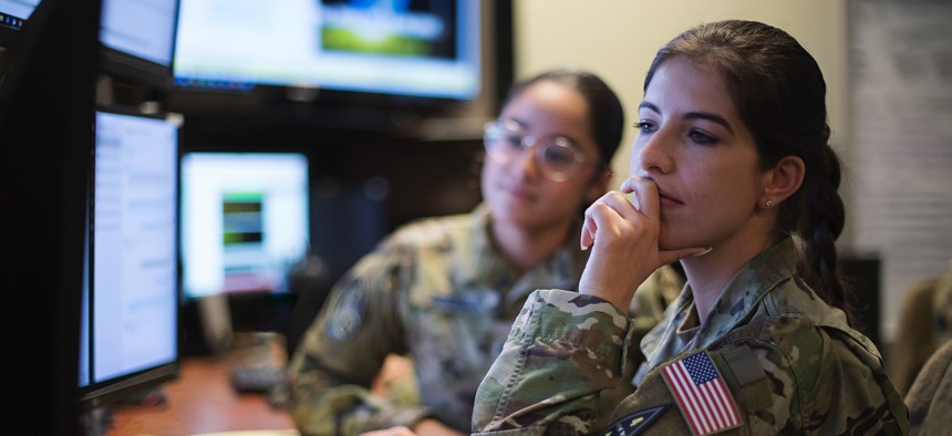 U.S. Space Force 1st Lt. Laura Drapinski, front, and Spc. 4 Ariana Gonzalez, use a Space-Based Infrared System Simulator to monitor missile indications during simulated combat operations at Schriever Space Force Base, Colorado, Dec. 13, 2022.