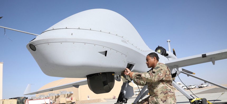 U.S. Army PFC Terry Hollywood, assigned to 224th Military Intelligence Battalion, conducts maintenance on a Grey Eagle in preparation for Project Convergence at Yuma Proving Ground, Arizona.