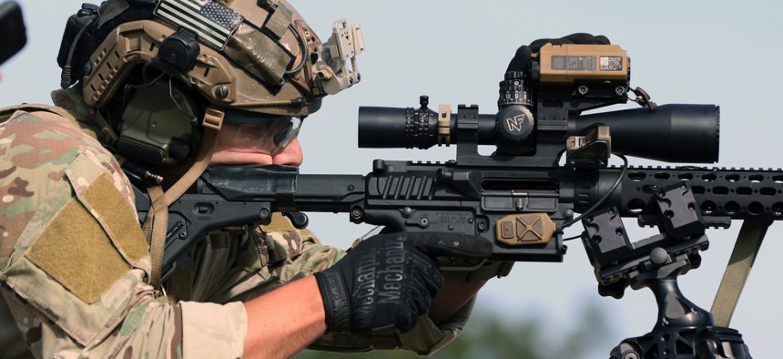 A competitor in the United States Army Special Operations Command International Sniper Competition uses a digital range finder on his weapon while engaging long-distance targets at Fort Bragg, North Carolina, March 19, 2019.