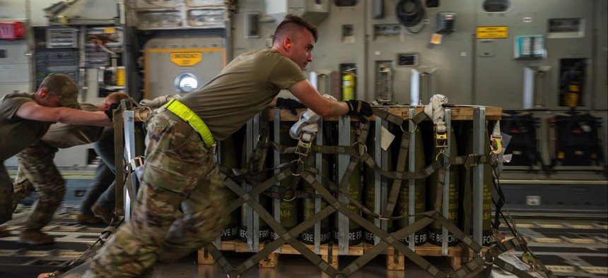 Airmen load pallets of ammunition onto a C-17 Globemaster III bound for Ukraine during a security assistance mission.