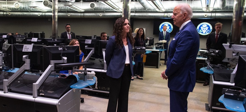 President Joe Biden speaks with the Director of the National Counterterrorism Center Christine Abizaid, as he tours the Center's Watch Floor at the Office of the Director of National Intelligence in McLean, Virginia, July 27, 2021.