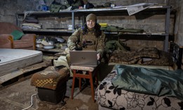 Ukrainian frontline paramedic "Kava" uses a Starlink internet connection in a basement living quarters as Russian shells nearby above ground on February 20, 2023 in the Donbas region of eastern Ukraine.