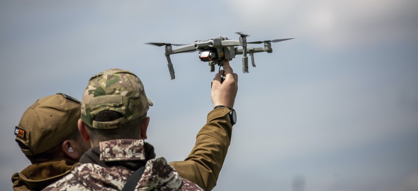 Ukrainian trainees learn to drop explosives devices from a drone in Ukraine, on May 12, 2023.
