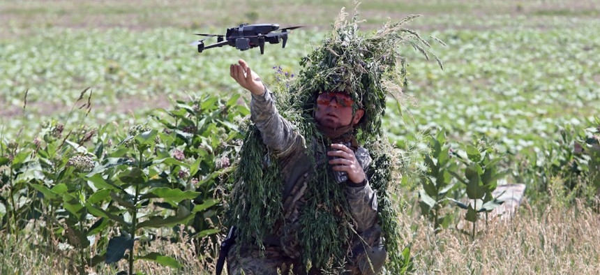  A camouflaged Ukrainian military pilot is seen in the field as the Army of Drones announces the second stage of the UAV pilot training that will see 10,000 military personnel learn how to fly the drones and join the Defence Forces with new skills