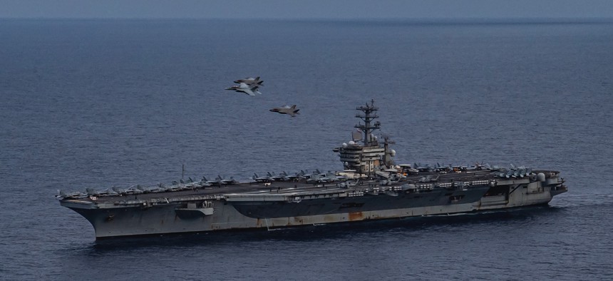 Aircraft from Nimitz Carrier Strike Group (NIMCSG) and Makin Island Amphibious Ready Group (MKI ARG) fly in formation past the aircraft carrier USS Nimitz (CVN 68)