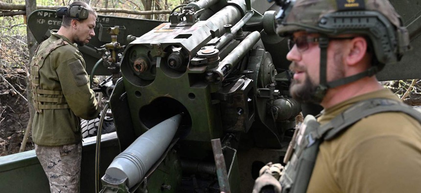 Ukrainian artillerymen fire toward Russian positions near Avdiivka in the Donetsk region on June 23, 2023.