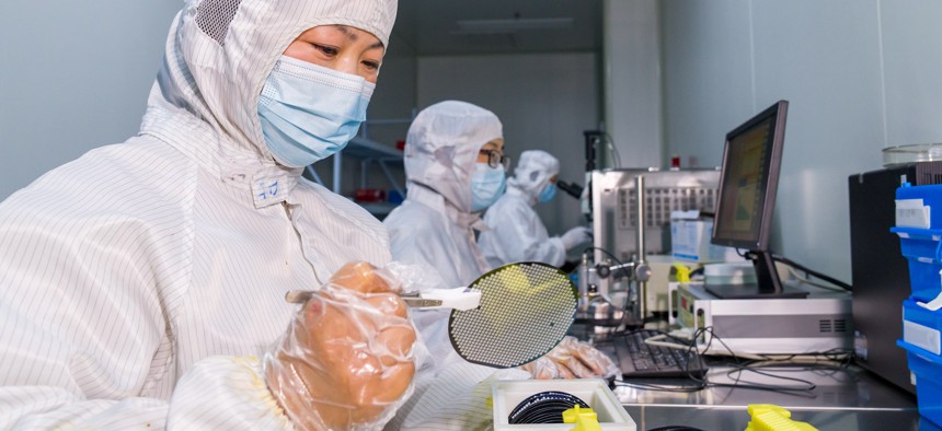 A worker makes and tests semiconductor power device chip products at a workshop of a microelectronics company in Binhai New Area, Hai 'an City, East China's Jiangsu Province, March 23, 2023.