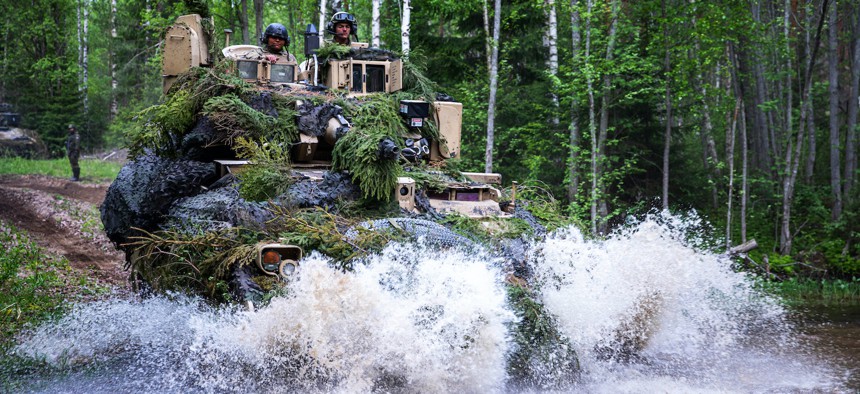 Soldiers navigate a Bradley fighting vehicle through the battlefield during Karelian Lock 23 in Pahkajarvi Training Area, Finland, May 31, 2023. 