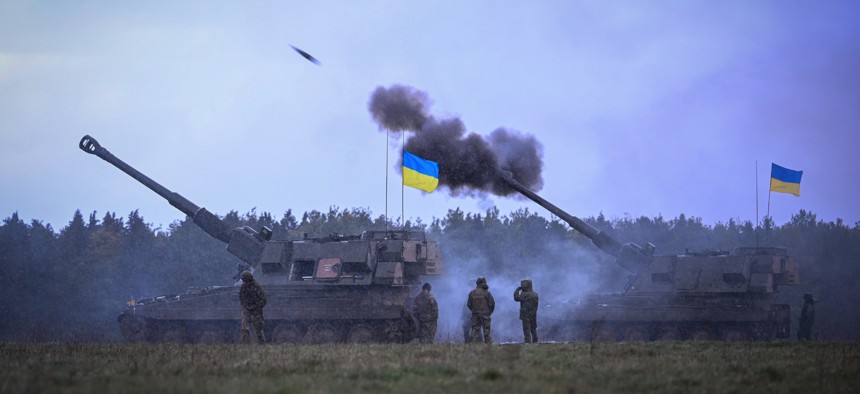 Ukrainian troops fire 155mm guns during training in southwest England in March 2023.