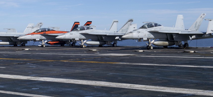 F/A-18F Super Hornets and an F/A-18E Super Hornet, from Carrier Air Wing (CVW) 17, rest on the flight deck of the aircraft carrier USS Nimitz in 2022.