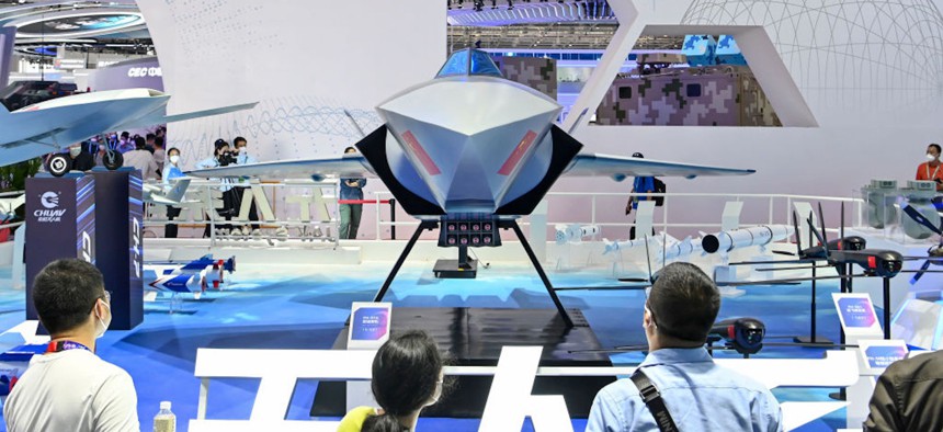 Visitors view the model of FH-97A 'loyal wingman' unmanned aircraft exhibited at the 14th China International Aviation and Aerospace Exhibition, on November 9, 2022 in Zhuhai, China.