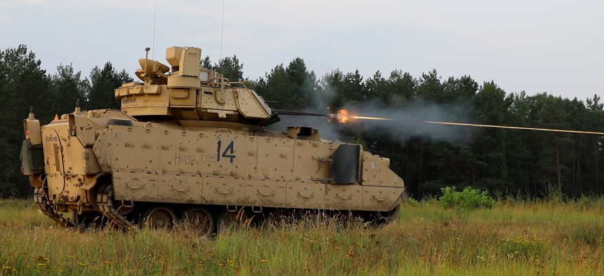 Soldiers with the 1st Cavalry Division fire the 25mm cannon on a Bradley Fighting Vehicle at a range in Poland in 2022.