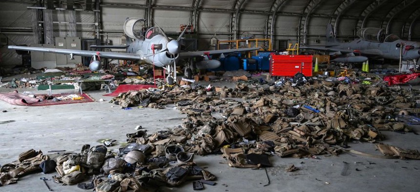 Afghan Air Force A-29 attack aircraft sit among body armor in a Kabul hangar on August 31, 2021.