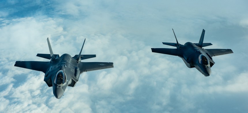 In this 2018 photo, two F-35A Lightning IIs fly in formation during a refueling mission over the Atlantic Ocean. The Air Force plans to buy enough robot wingman aircraft for 300 F-35s to get two each. 