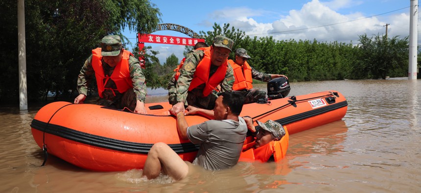 Rescue teams work in Harbin on August 5, 2023, after Typhoon Doksuri brought flooding to China's Heilongjiang Province.