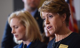 In this 2014 photo, Paula Coughlin (R) speaks as Senator Kirsten Gillibrand (L), D-NY, looks on during a press conference calling for the creation of an independent military justice system to deal with sexual harassment and assault in the military. 