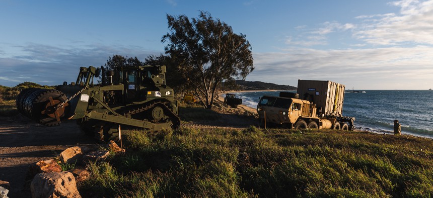 U.S. Army vehicles successfully land on the beach from a Floating Causeway in Bowen North Queensland during Exercise Talisman Sabre, July 31, 2023.