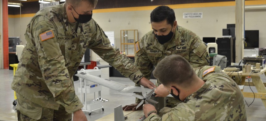 101st Airborne Division soldiers add a 3D-printed propeller to an RQ-11B Raven for a test run at the EagleWerx Applied Tactical Innovation Center in 2019.