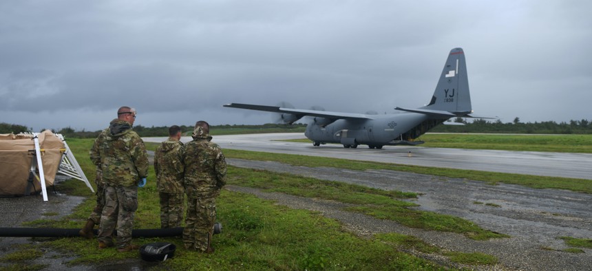 U.S. Air Force airmen prepare to off-load fuel from a C-130J Super Hercules, July 21, 2021, at Tinian International Airport, Tinian, during an agile combat employment exercise. 