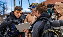 Sailors assigned to Mobile Diving and Salvage Unit One (MDSU-1) discuss search and survey operations in Lahaina Harbor in Maui, Aug. 27, 2023.