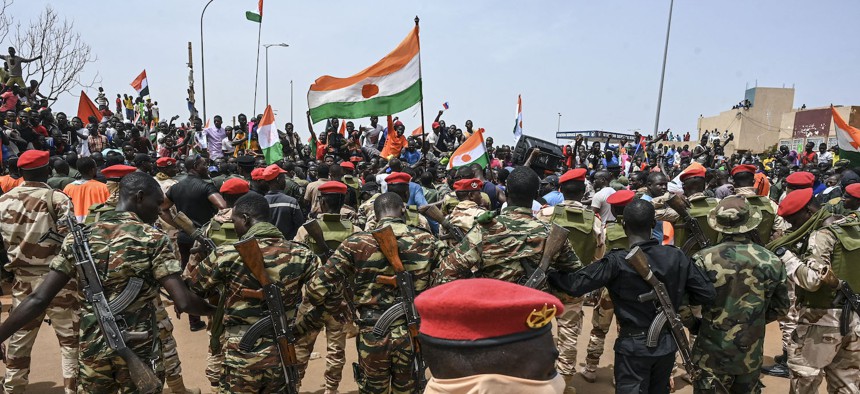 Nigerien soldiers stand guard as supporters of Niger's National Council of Safeguard of the Homeland (CNSP) protest outside the Niger and French airbase in Niamey on September 2, 2023 to demand the departure of the French army from Niger.