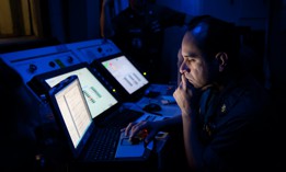 In this 2012 photo, Chief Aviation Machinist's Mate Eddie Casusol reviews test data from an F/A-18 engine test in the jet shop aboard the Nimitz-class aircraft carrier USS John C. Stennis.