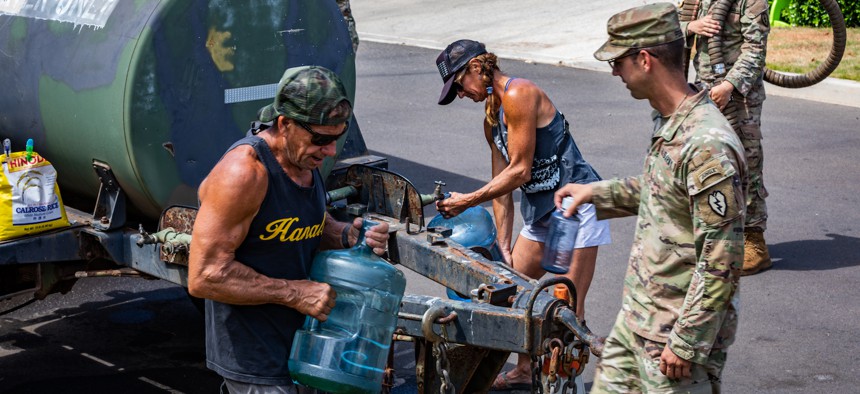Soldiers from 225th Brigade Support Battalion, 2nd Infantry Brigade Combat Team, 25th Infantry Division and members of Joint Task Force 5-0 distribute water to residents of Lahaina, Maui, Aug. 30, 2023.