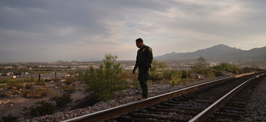  A U.S. Border Patrol agent walks near Sunland Park, New Mexico, on June 29, 2023.