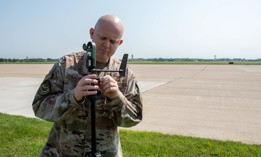 Senior Master Sgt. Michael Adcock sets up a Kestrel on the flightline at Scott Air Force Base, Ill., Aug. 25, 2020.