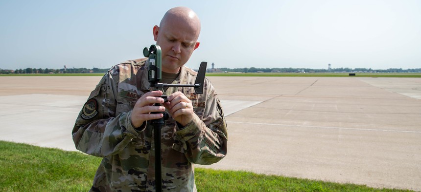 Senior Master Sgt. Michael Adcock sets up a Kestrel on the flightline at Scott Air Force Base, Ill., Aug. 25, 2020.