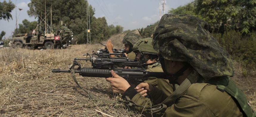 Israeli soldiers patrol near the border with Gaza on October 10, 2023 in Kfar Gaza, Israel.