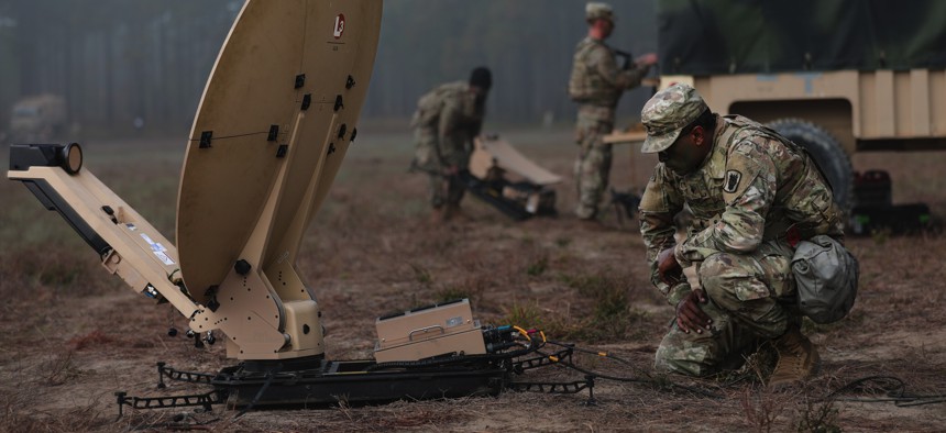 Soldiers from the 50th Expeditionary Signal Battalion-Enhanced (ESB-E), 35th Corps Signal Brigade, set up their equipment during a field training exercise on Oct. 26, 2022, at Fort Bragg, N.C.