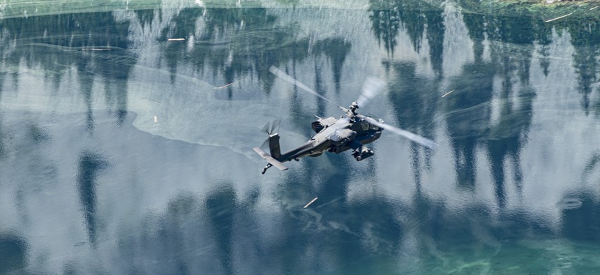 An AH-64E Apache helicopter flies near Blanca Lake, Wash., July 11, 2022.