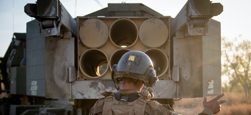 U.S. Marine Corps Cpl. Cole Strain loads a Guided Multiple Launch Rocket System into a launcher during Exercise Koolendong at Bradshaw Field Training Area, NT, Australia, Aug. 29, 2021.