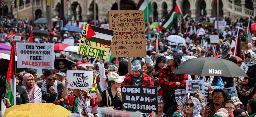 People gather during a Freedom for Palestine rally at Merdeka Square on October 22, 2023, in Kuala Lumpur, Malaysia.  