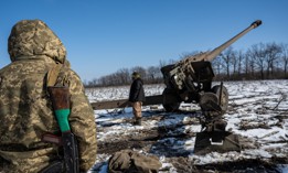 Armed with rifles to shoot down any incoming Russian drones, a Ukrainian artillery team races to set up their 152mm cannon in the southern Donbas region, Ukraine, on February 19, 2023. 