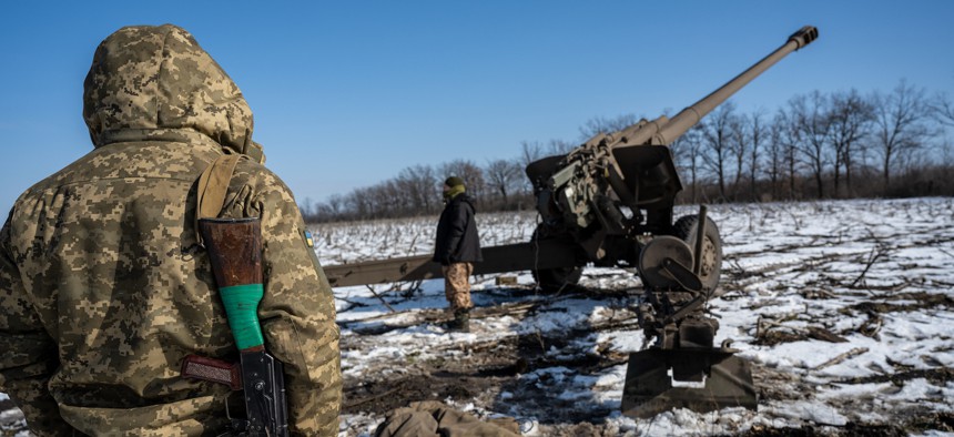 Armed with rifles to shoot down any incoming Russian drones, a Ukrainian artillery team races to set up their 152mm cannon in the southern Donbas region, Ukraine, on February 19, 2023. 